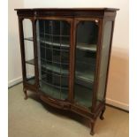 An Edwardian mahogany and inlaid display cabinet the single leaded glazed bow fronted door flanked