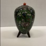 An early 20th Century Chinese cloisonne egg shaped pot and cover decorated with panels of exotic