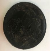 A Japanese bronze plate depicting storks/cranes in a landscape with stylised leaf decoration,