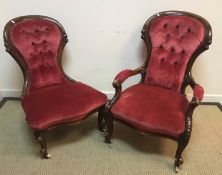 A pair of Victorian ladies and gents walnut framed salon chairs with button backs on cabriole front