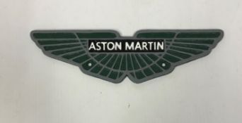 A modern painted cast iron sign inscribed "Aston Martin",