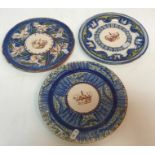 A collection of three Continental porcelain plates each depicting a crown to the centre highlighted
