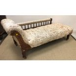 A late Victorian walnut framed chaise longue with galleried back rail on turned legs to casters 180