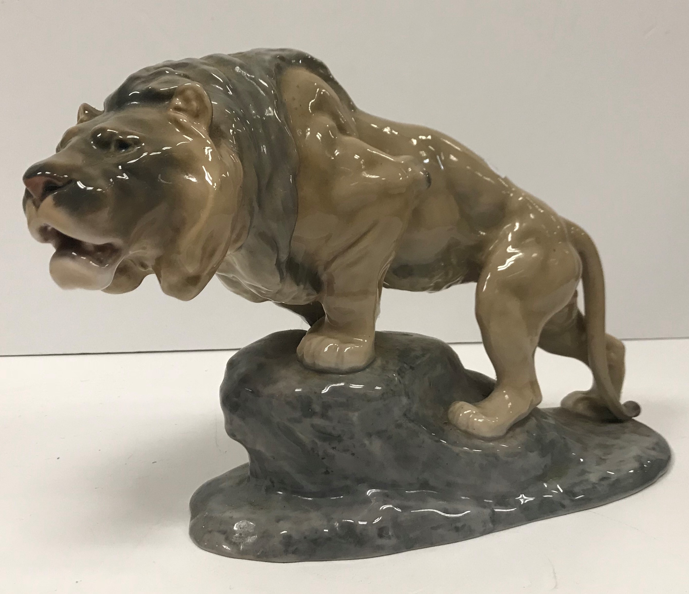 A Bing & Grondahl Copenhagen figure of a “Lion upon a rock”,