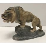 A Bing & Grondahl Copenhagen figure of a “Lion upon a rock”,