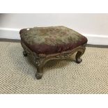 A Victorian carved giltwood and gesso framed footstool with aubusson style floral tapestry seat on