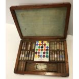 A mahogany cased artists paintbox containing various paints and porcelain plaque inside inscribed