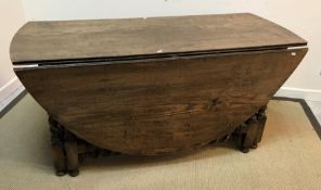 An oak oval double gate-leg drop-leaf dining table on barley-twist supports in the 17th Century