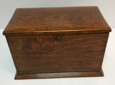 An early 20th Century oak stationery box with twin handles,