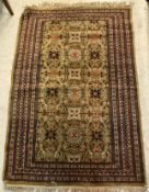 A Persian carpet, the central panel set with all-over floral design on a pale green ground,