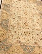 A Persian carpet, the central panel set with all-over floral decoration on a cream ground,
