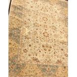 A Persian carpet, the central panel set with all-over floral decoration on a cream ground,