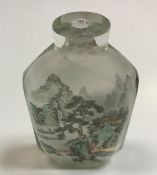 A Chinese facet cut glass snuff bottle interior decorated with figure in a boat in a lake landscape