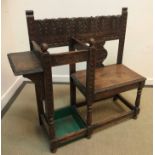 A late Victorian carved oak Gothic Revival single seat hall seat with stick stand and shelf on