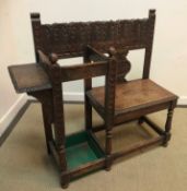 A late Victorian carved oak Gothic Revival single seat hall seat with stick stand and shelf on