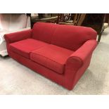 A modern red upholstered scroll arm two seat sofa, 176 cm wide x 85 cm deep x 78 cm high,