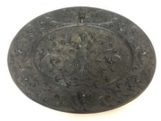 A cast metal plaque depicting "Woman in the Classical manner", within scrolling decoration,