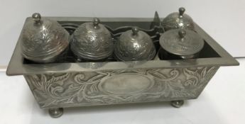 A 20th Century pewter betel box with five lidded containers within a rectangular foliate decorated