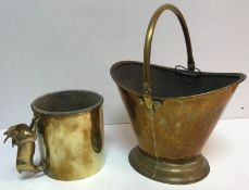 A brass coal bucket of boat form raised on a stepped foot 31 cm high excluding handle together with