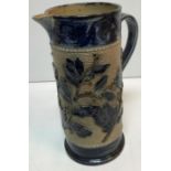 A Victorian glazed stoneware jug with holly decoration,