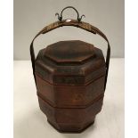 A South East Asian octagonal food container with cane work and metal handle and painted / gilded