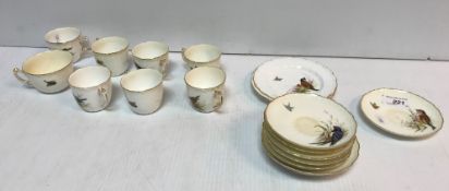 A Royal Worcester part tea set decorated with birds to the cups,