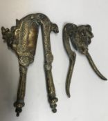 A 19th Century Indonesian brass betel nut cutter of stylised beast form with scrollwork foliate