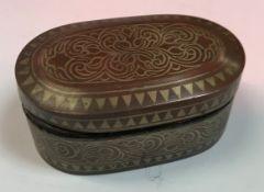 A 19th Century Maranao brass damascened copper betel box of elongated oval form decorated in the