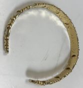 An Italian 18 carat bangle of segmented form, 6 cm diameter,