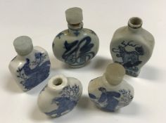 A Chinese blue and white flattened baluster shaped snuff bottle each side decorated with Kylin,