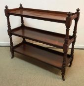 A Victorian mahogany three tier dumb waiter on turned and ringed supports to turned feet and