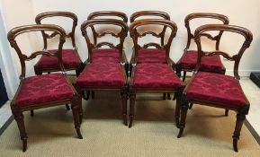 A set of eight Victorian mahogany kidney back dining chairs with drop in seats on turned and carved