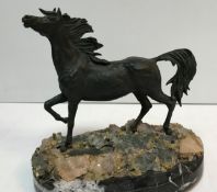 An Italian bronze horse study raised on a quartz decorated base to marble socle,