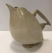 An Anthony Theakston sparrow beak jug in the form of a bird in stone coloured glaze,
