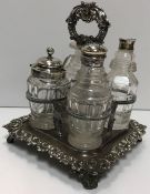 A box containing Victorian plated four section cruet stand and collection of four glass bottles,