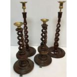 Two pairs of modern mahogany candlesticks with barley twist decoration and brass sconces and drip