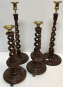Two pairs of modern mahogany candlesticks with barley twist decoration and brass sconces and drip