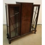 A 1930s walnut display cabinet of stylised sunburst form,