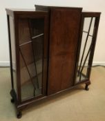 A 1930s walnut display cabinet of stylised sunburst form,