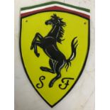 A modern painted cast iron sign bearing "Ferrari" emblem, approx 29.