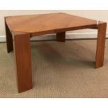 A modern cherry wood coffee table by Ashley Cartwright, raised on triangular supports,