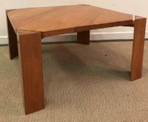 A modern cherry wood coffee table by Ashley Cartwright, raised on triangular supports,