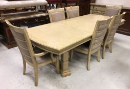 A modern stained oak and ash extending dining table on square ringed supports united by a centre