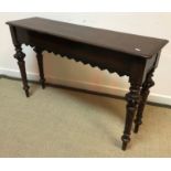 A Victorian oak side table of slim proportions,