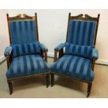 A pair of late Victorian stained beech salon armchairs with foliate carved top rail above