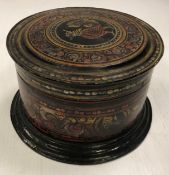 A Burmese black lacquered cylindrical betel box 24 cm diameter x 14 cm high