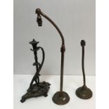 Two early 20th Century adjustable brass table lamps raised on circular bases together with a