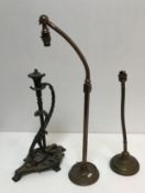 Two early 20th Century adjustable brass table lamps raised on circular bases together with a
