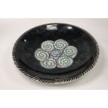 An Alfred Powell for Wedgwood charger with lustre decoration and central floral medallion,