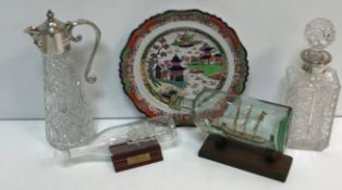 Two various model ships in bottles, a moulded glass claret jug with plated mounts,